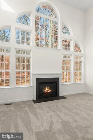 a view of an empty room with a window and a ceiling fan