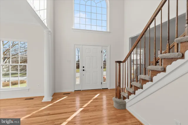 a view of an entryway with wooden floor and door