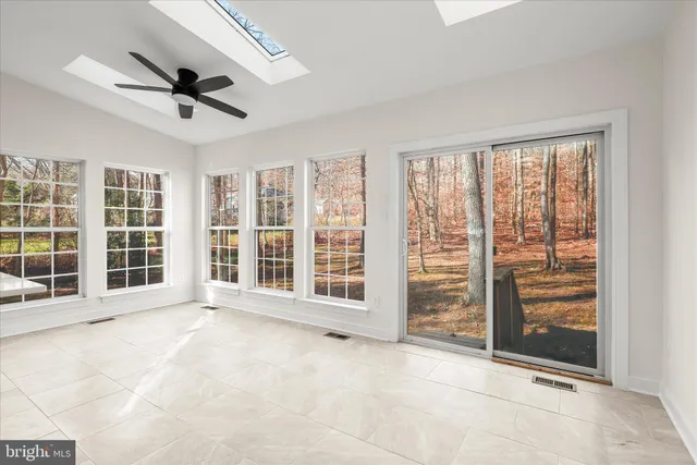 a view of a livingroom with an empty space and a window