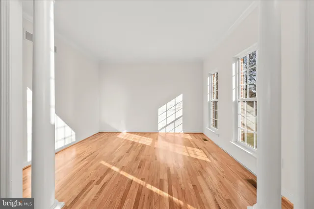 a view of a livingroom with wooden floor a fireplace and entryway