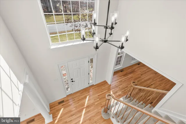 a view of an empty room with kitchen and a window