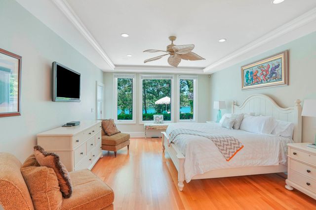 a bedroom with a bed and a large window