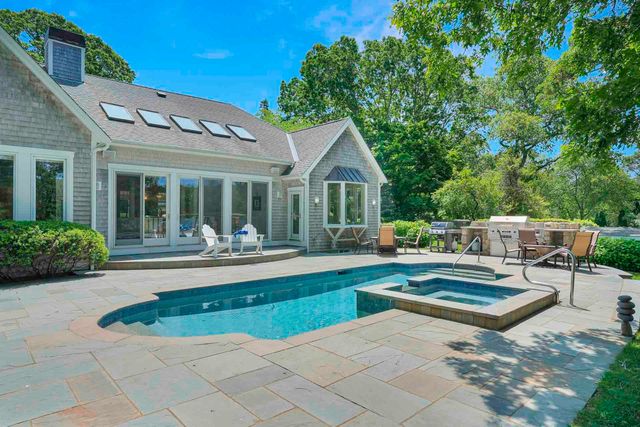 a view of a house with swimming pool and sitting area