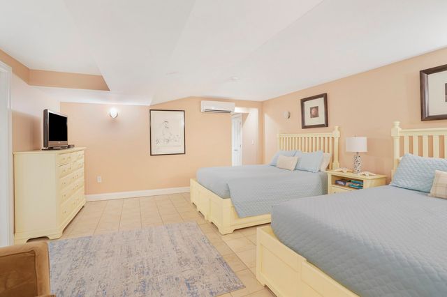 a front view of a house with a yard and a garage