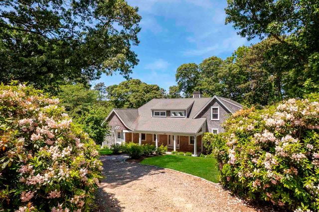 a view of entryway and hall with wooden floor and a front door