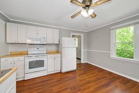 1811 Prairie Street Glenview, IL 60025 - Photo 6 of 22 a kitchen with a refrigerator stove and white cabinets