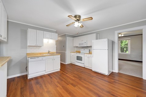 1811 Prairie Street Glenview, IL 60025 - Photo 7 of 22 a kitchen with a refrigerator and white cabinets
