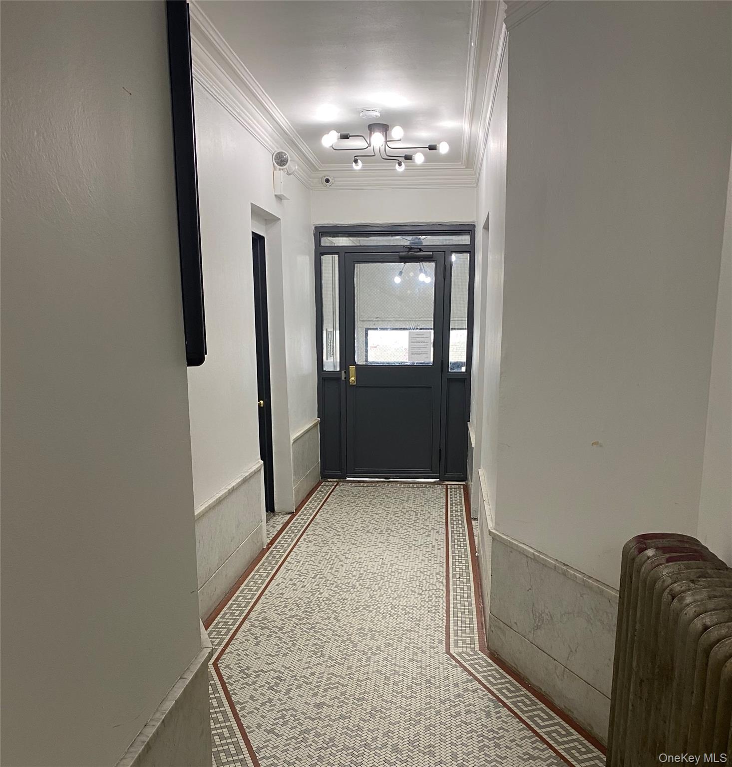 1383 Plimpton Avenue, Unit 4C Bronx, NY 10452 - Photo 3 of 5 wooden floor in an empty room with a mirror