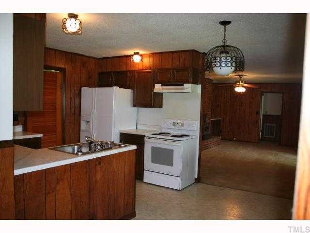 1188 Tower Road Norlina, NC 27563 - Photo 6 of 12 Kitchen and family room with wood insert fireplace and built-in on each side