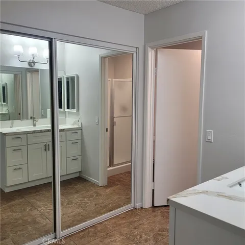 a bathroom with a sink shower and a mirror