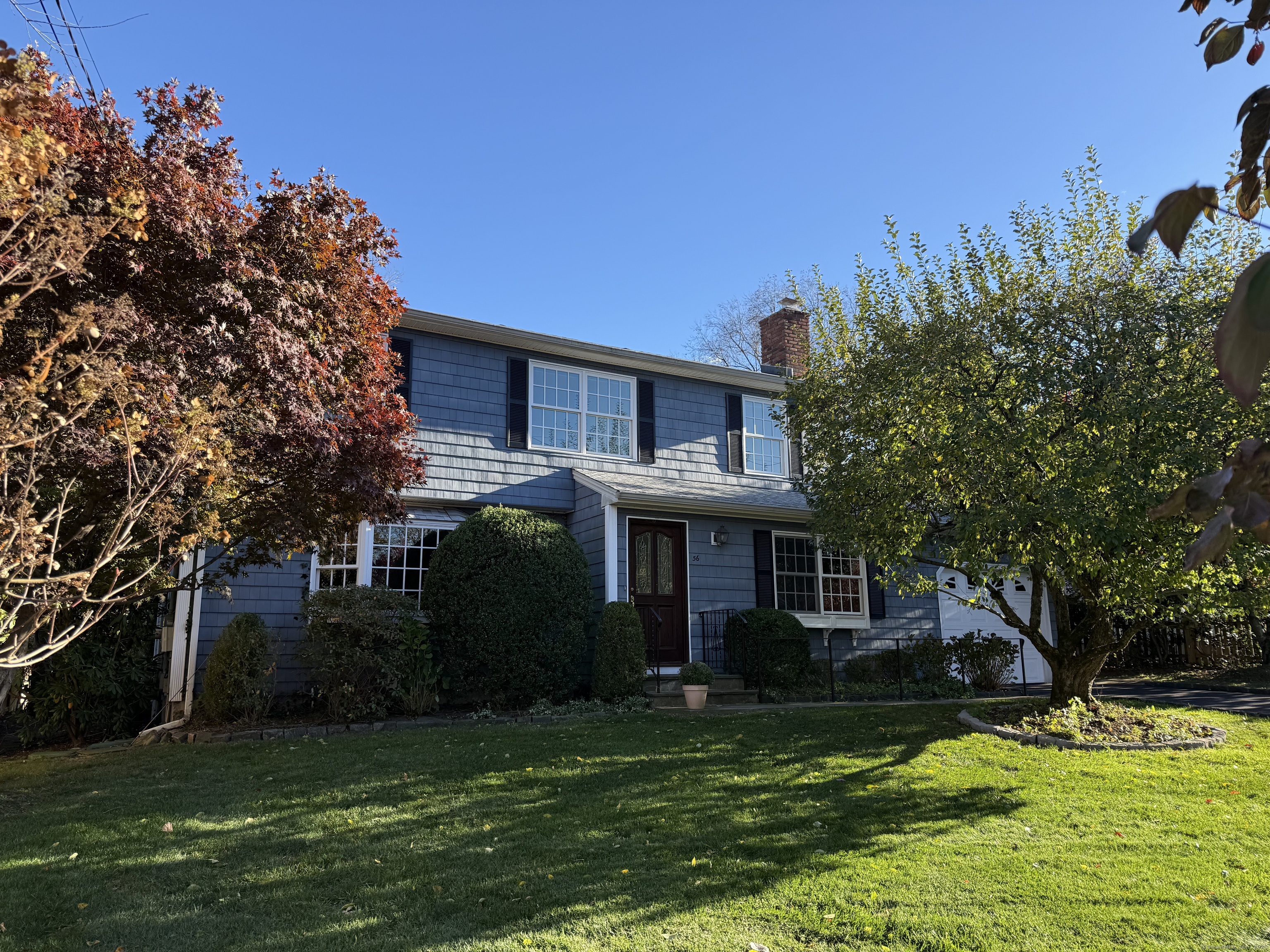 a front view of a house with a garden
