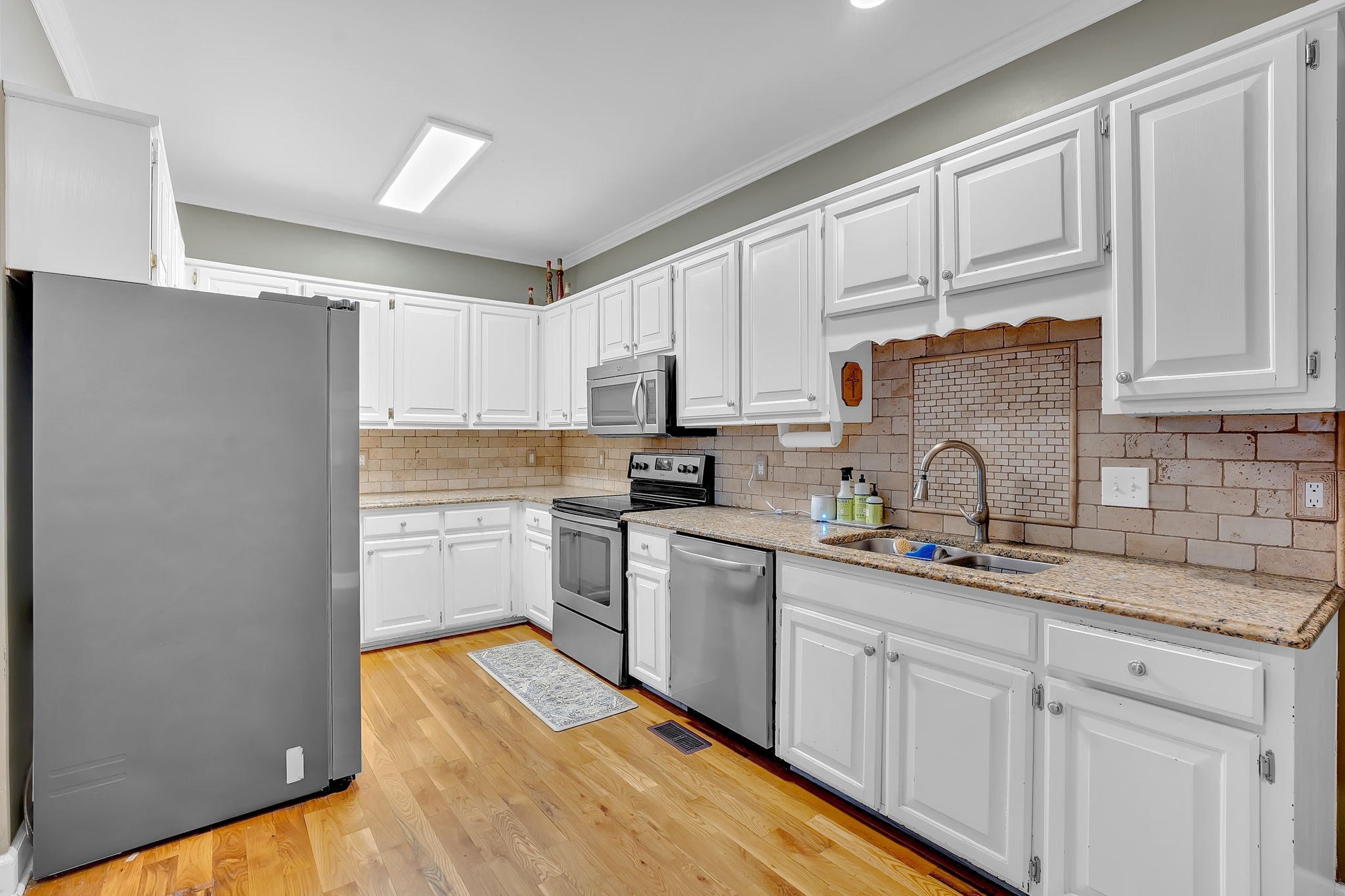 2115 Battleground Drive Murfreesboro, TN 37129 - Photo 13 of 40 a kitchen with cabinets stainless steel appliances and a sink