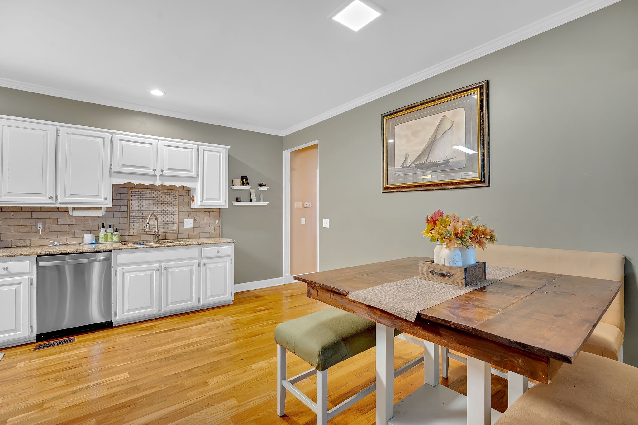 2115 Battleground Drive Murfreesboro, TN 37129 - Photo 14 of 40 a kitchen with granite countertop a table chairs sink and cabinets