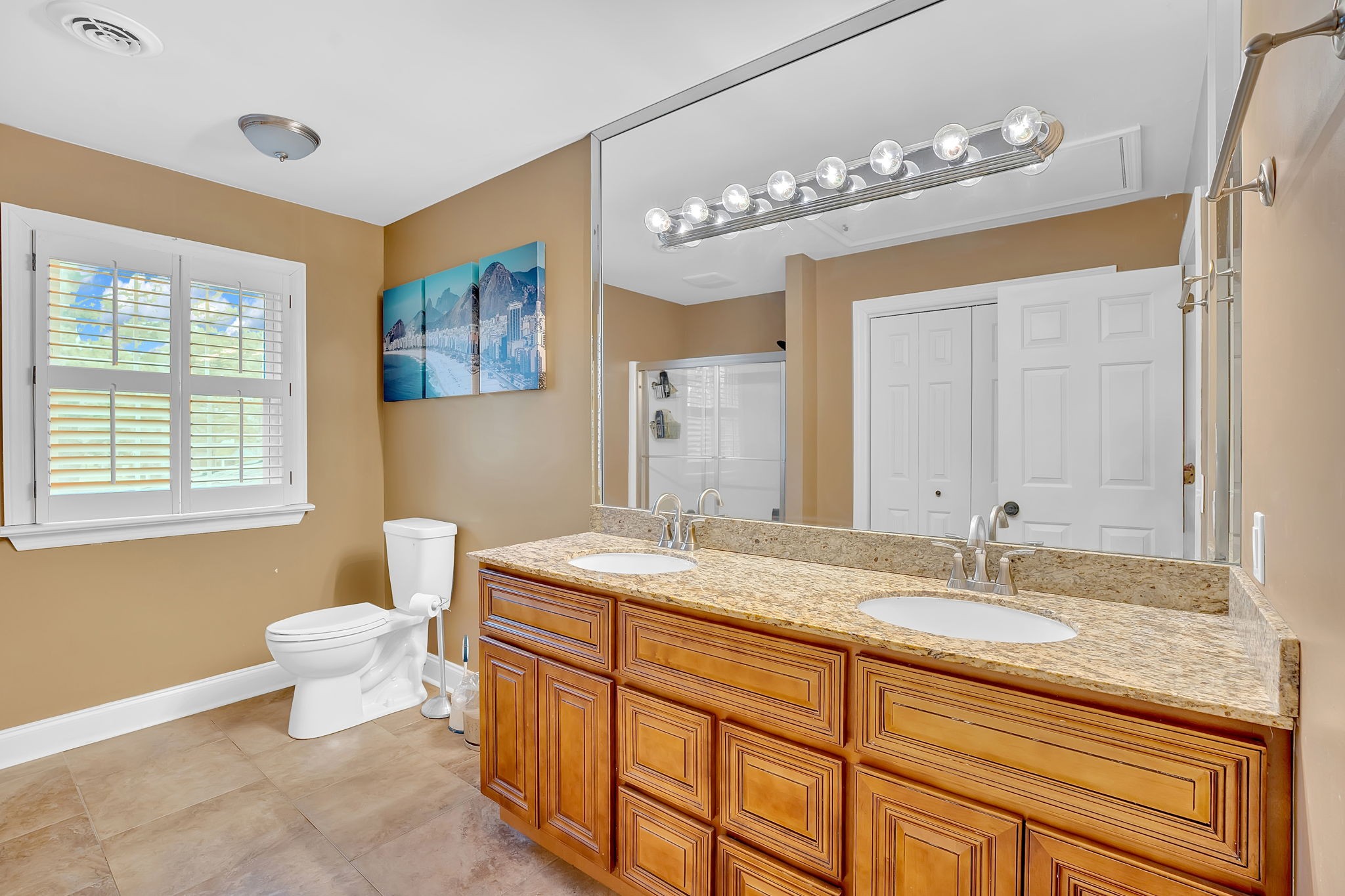 2115 Battleground Drive Murfreesboro, TN 37129 - Photo 32 of 40 a bathroom with a granite countertop sink a toilet a mirror and shower
