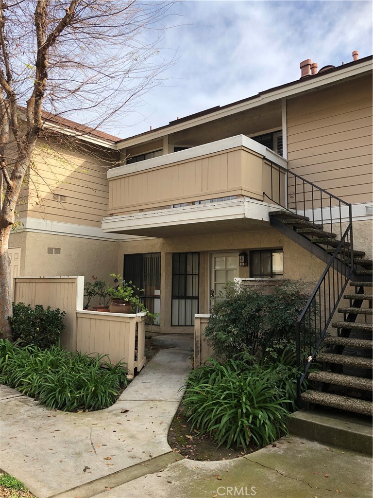a front view of a house with plants