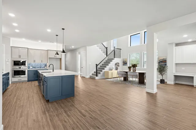 a view of a kitchen with wooden floor and a kitchen
