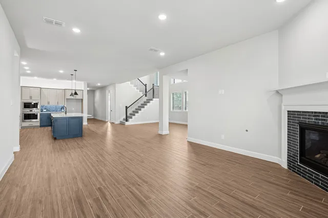 a view of a kitchen with wooden floor and a kitchen