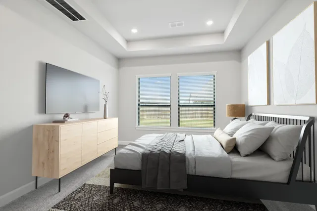 a large white bed sitting in a bedroom next to a window