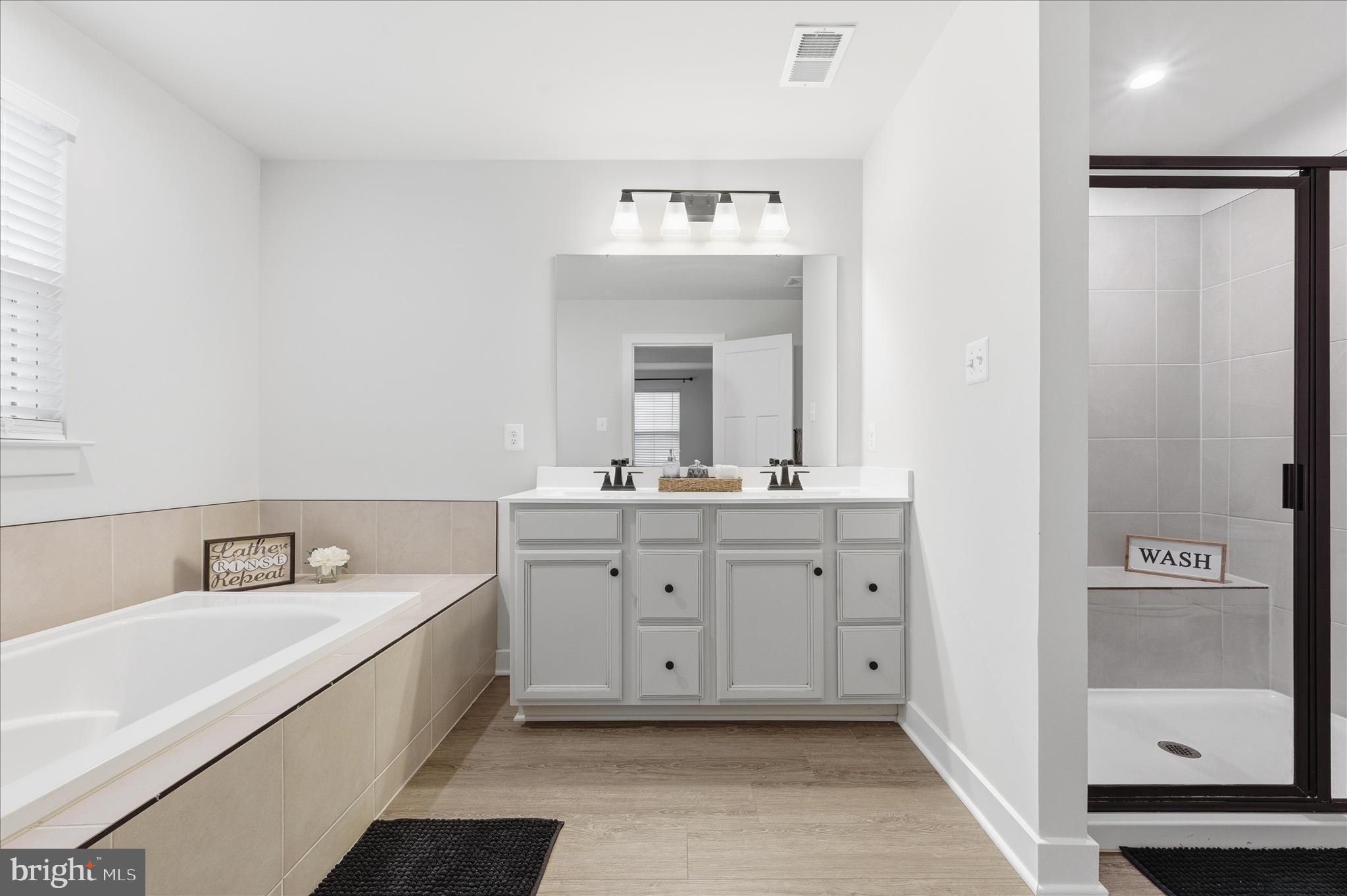 516 Rushbrook Road Martinsburg, WV 25403 - Photo 13 of 86 a bathroom with a double vanity sink mirror and bathtub