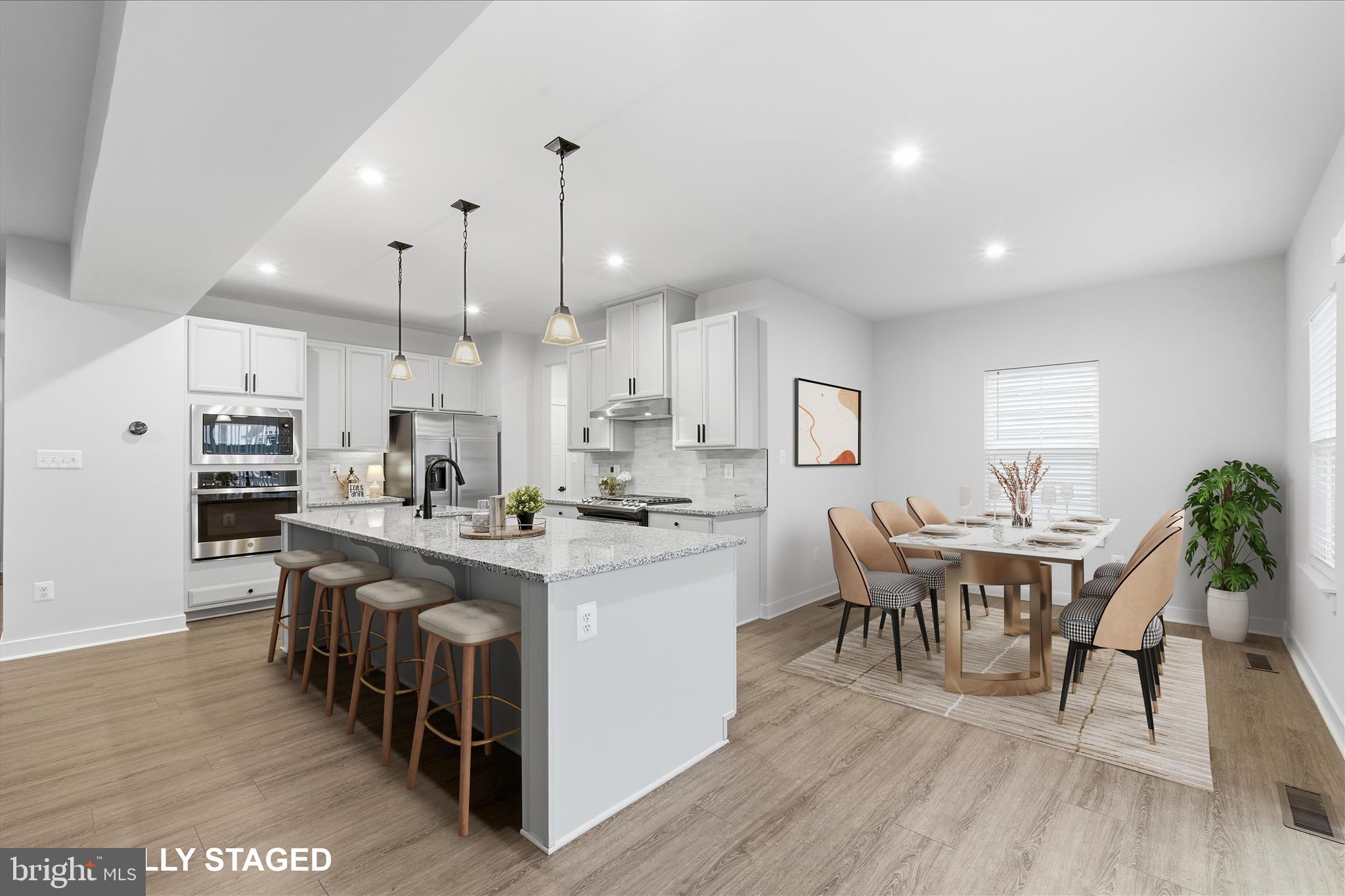 516 Rushbrook Road Martinsburg, WV 25403 - Photo 3 of 86 a kitchen with stainless steel appliances kitchen island granite countertop a table chairs sink and cabinets