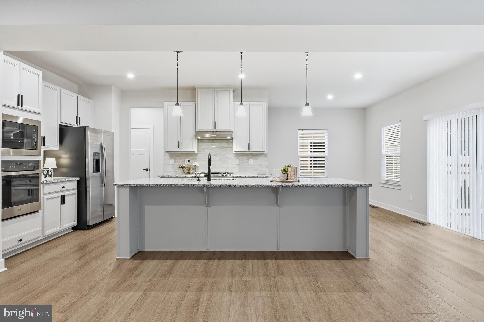 516 Rushbrook Road Martinsburg, WV 25403 - Photo 5 of 86 a kitchen with stainless steel appliances granite countertop a sink a stove a refrigerator and island with wooden floor