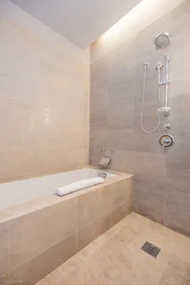 a bathroom with a granite countertop sink a toilet and shower