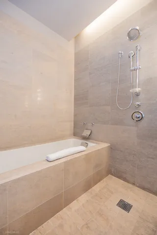 a bathroom with a granite countertop sink a toilet and shower