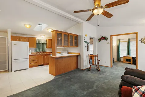 a kitchen with stainless steel appliances kitchen island granite countertop a refrigerator and a stove top oven