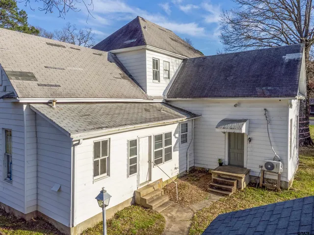 a front view of a house with chairs