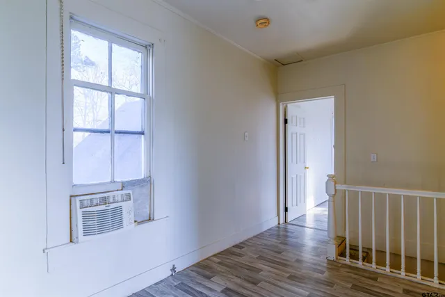a view of entryway with wooden floor and stairs