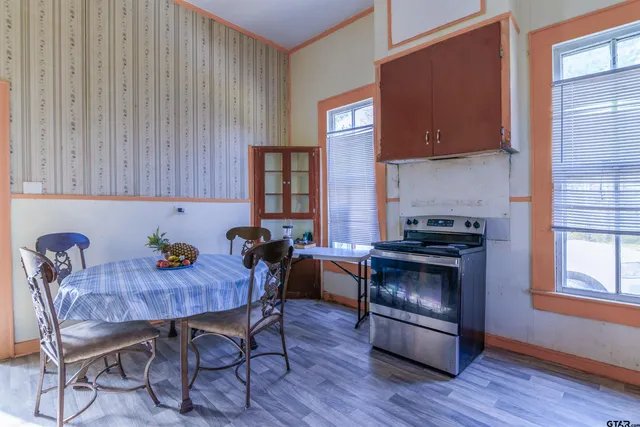 a kitchen with granite countertop wooden cabinets a sink and a stove