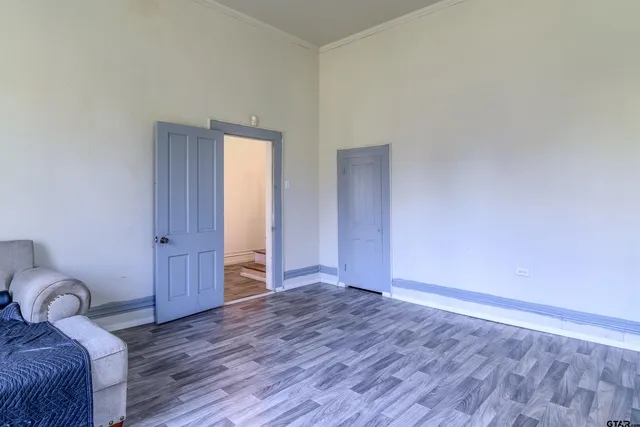 a living room with furniture and a window with wooden floor