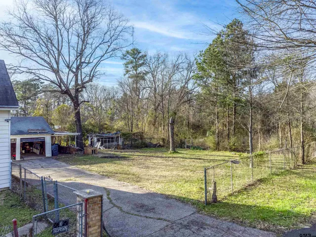 a view of a yard with swimming pool