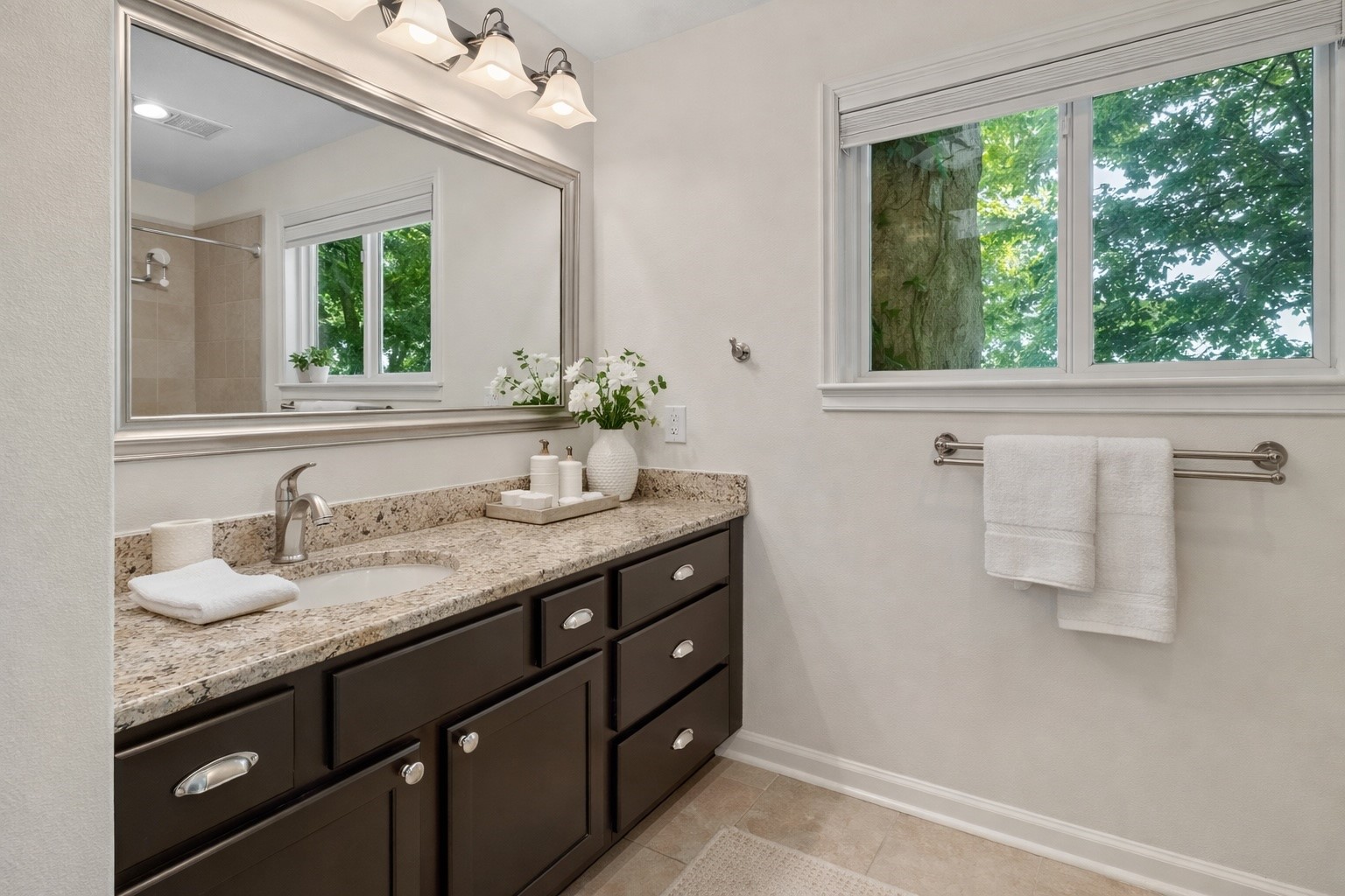 603 Granberry Street Humble, TX 77338 - Photo 11 of 16 a bathroom with a granite countertop sink and a mirror