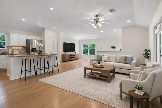 a living room with furniture and kitchen view