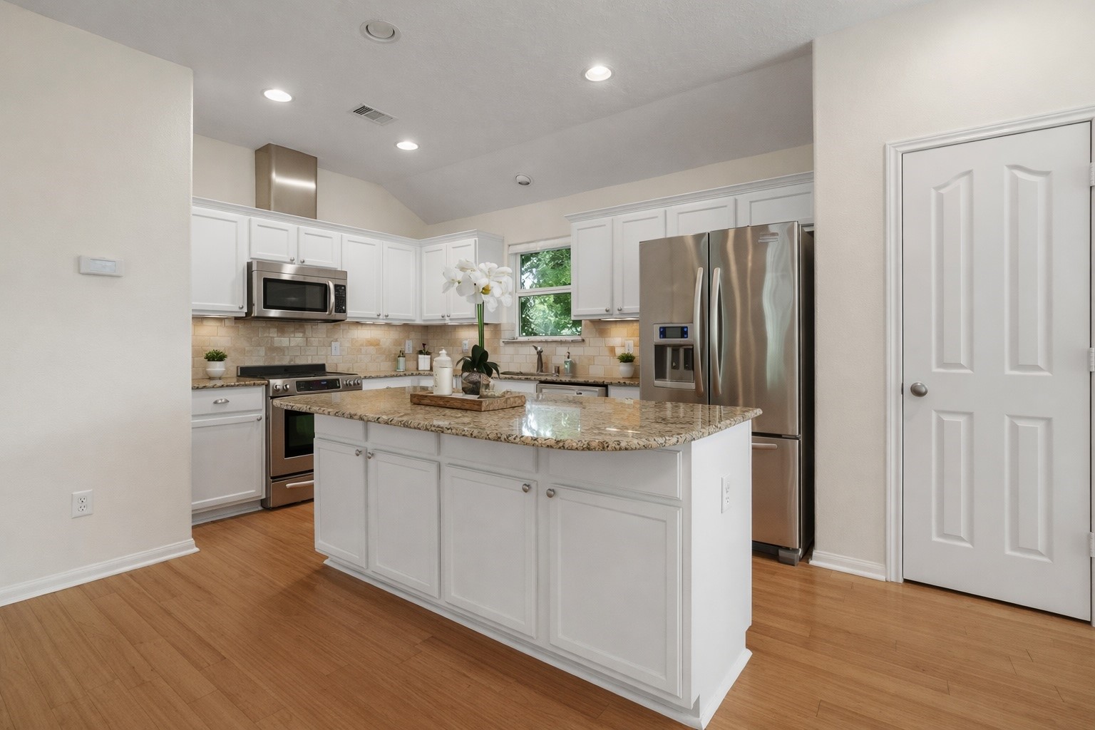 603 Granberry Street Humble, TX 77338 - Photo 4 of 16 a kitchen with stainless steel appliances granite countertop a refrigerator sink and stove