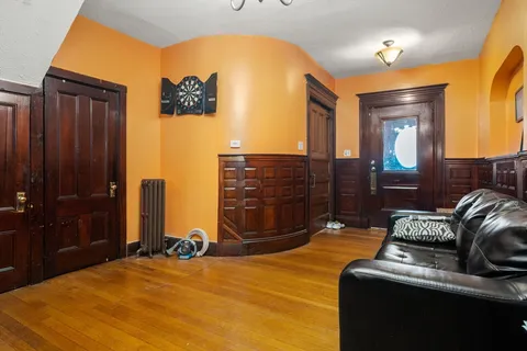 a bedroom with a bed and dresser with mirror
