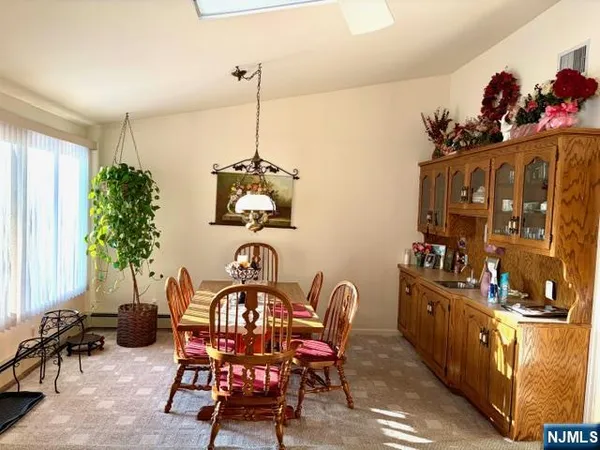 a view of a dining room with furniture and chandelier
