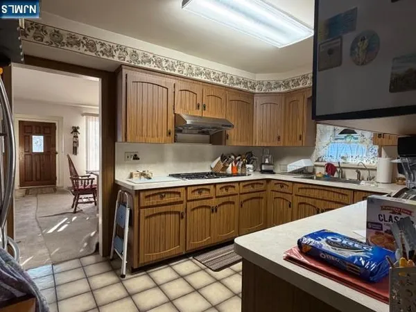 a kitchen with granite countertop a sink stove and cabinets