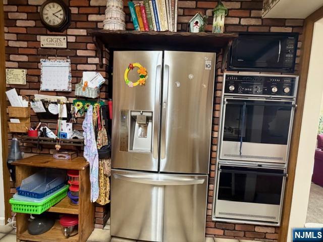 6 Patton Street Lodi, NJ 07644 - Photo 9 of 13 a kitchen with stainless steel appliances and a refrigerator