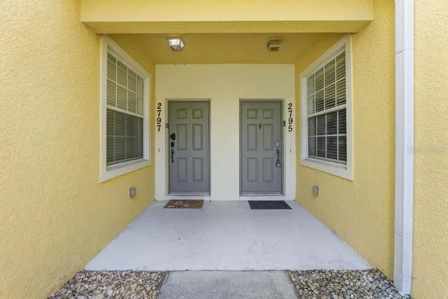 a view of a hallway with wooden floor and a window