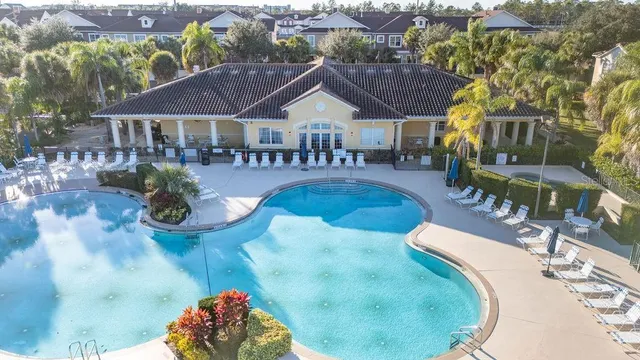 a aerial view of a house with outdoor space and lake view