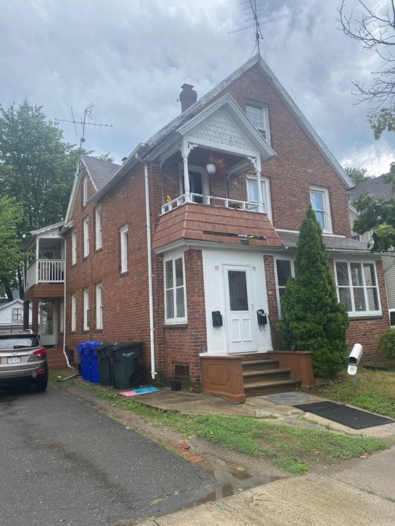 91-93 Grover Street Springfield, MA 01104 - Photo 1 of 12 a front view of a house with a garden