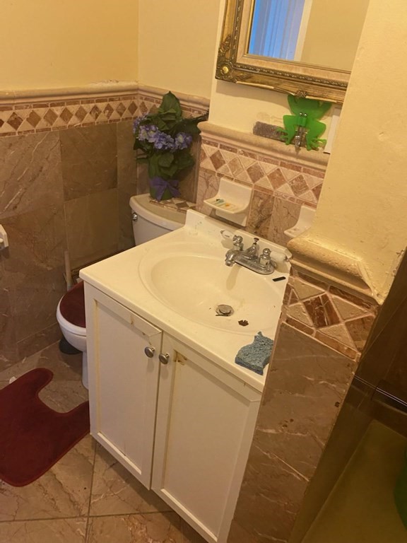 91-93 Grover Street Springfield, MA 01104 - Photo 8 of 12 a dirty bathroom with a sink and toilet