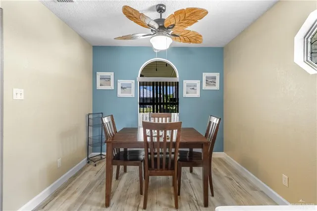 a view of a dining room with furniture and wooden floor