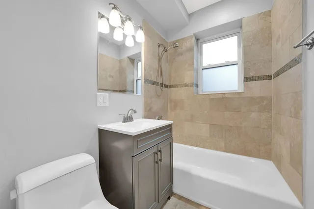 a bathroom with a sink a toilet and bathtub