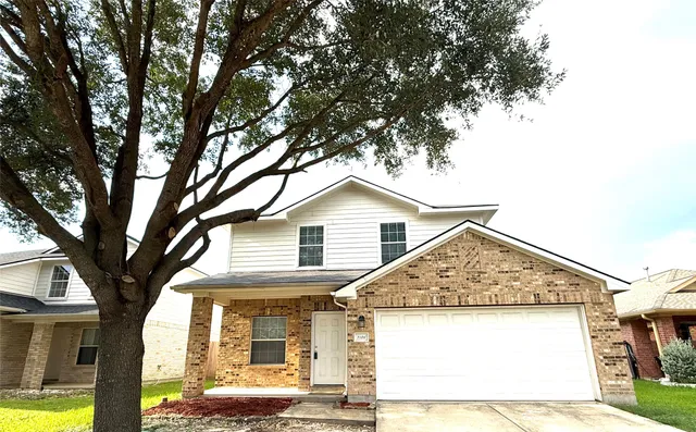 a view of a house with a tree beside it