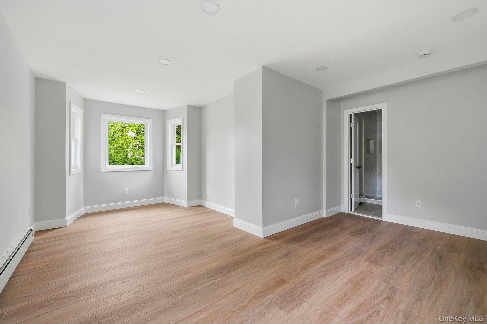 101 Rustic Road Centereach, NY 11720 - Photo 31 of 42 a view of an empty room with window and wooden floor