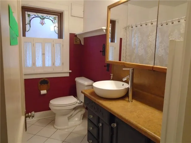 a bathroom with a granite countertop toilet a sink and a shower