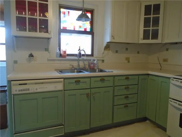 a kitchen with cabinets and window